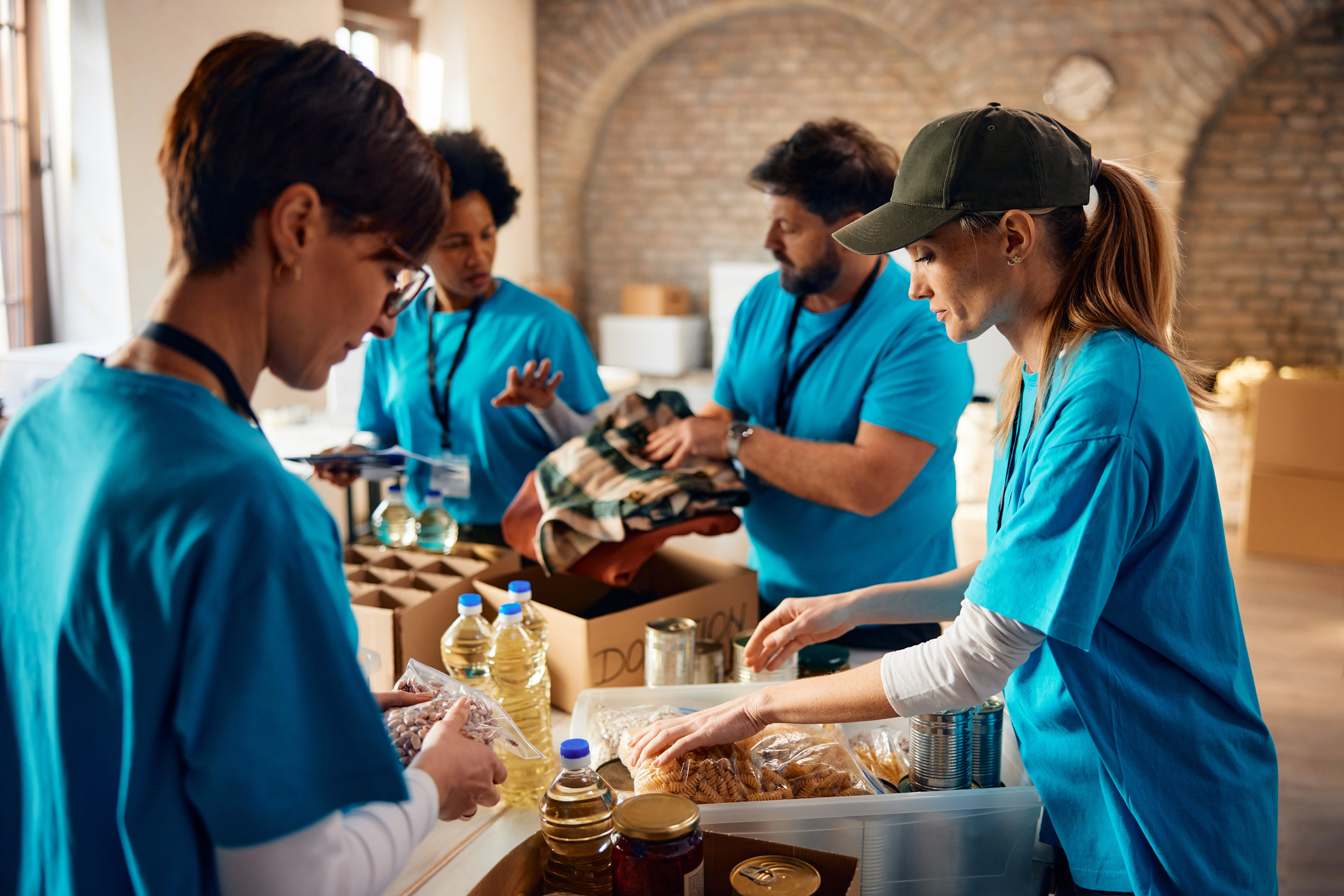 Multiracial,Group,Of,Volunteers,Packing,Groceries,At,Community,Food,Bank. Notforprofits_2